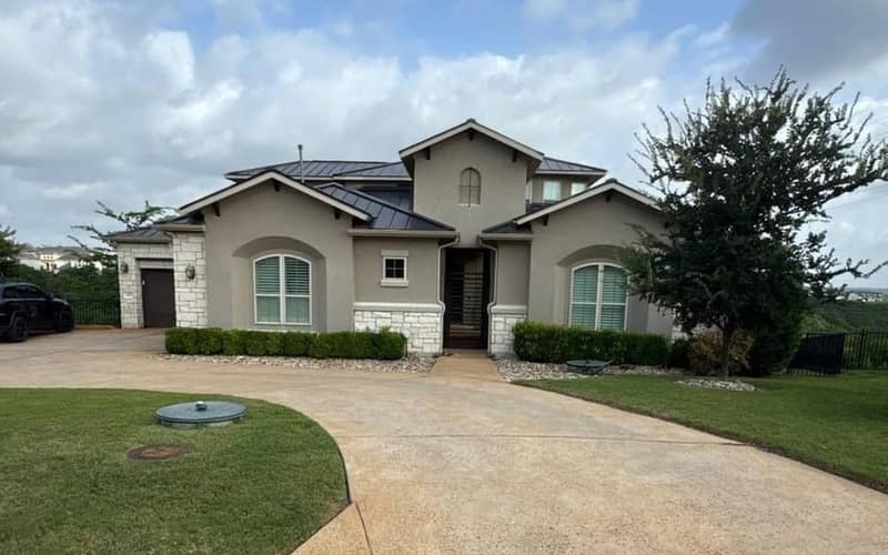 The same house with a matte black McElroy standing-seam metal roof