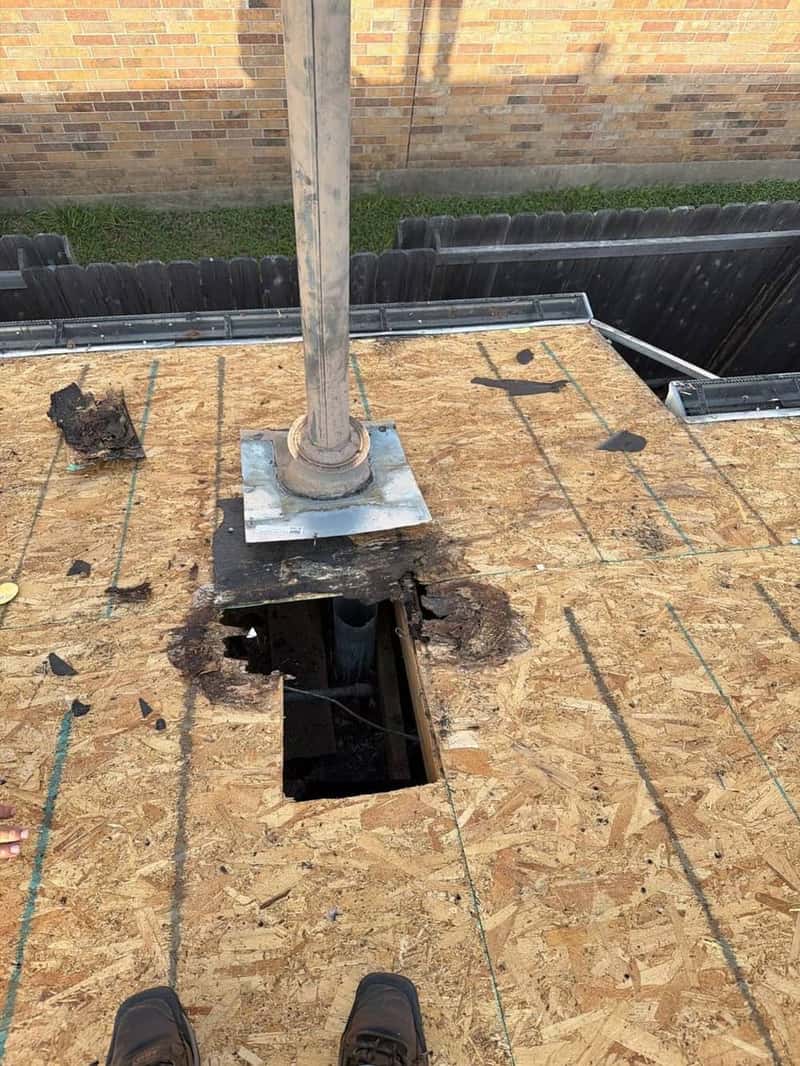 Rotted roof decking discovered around a plumbing vent stack during tear-off